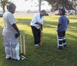 Theo Hayes showing cricket to youth